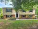 Charming two-story home with tan siding, black shutters, and a well-manicured front lawn at 7021 Willow Bend Ln, Mint Hill, NC 28227