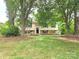 Traditional home with a welcoming lawn, mature trees, and a charming exterior at 7021 Willow Bend Ln, Mint Hill, NC 28227