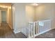 Upstairs hallway with vinyl floors and white railing overlooking the spacious downstairs living area at 7021 Willow Bend Ln, Mint Hill, NC 28227