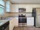 Bright kitchen featuring white cabinets, stainless steel appliances, and granite countertops at 7021 Willow Bend Ln, Mint Hill, NC 28227