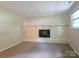 Cozy living room featuring a white brick fireplace and carpeted floors at 7021 Willow Bend Ln, Mint Hill, NC 28227