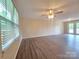 Bright living area featuring luxury vinyl floors and a glass door to the backyard at 7021 Willow Bend Ln, Mint Hill, NC 28227
