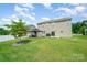 Spacious backyard with lush lawn, a gazebo, and a home exterior with neutral siding at 711 Saddlebred Ln, Locust, NC 28097