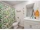 Bright bathroom featuring a single sink vanity with cabinets, shower with leaf-patterned curtain, and a decorative mirror at 711 Saddlebred Ln, Locust, NC 28097