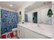 Fun bathroom with a dual sink vanity, bright Minecraft themed shower curtain, and a vibrant, playful design at 711 Saddlebred Ln, Locust, NC 28097