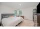 Cozy bedroom featuring a comfortable bed, ample natural light, and neutral decor, offering a peaceful ambiance at 711 Saddlebred Ln, Locust, NC 28097