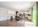 Open-concept kitchen and dining area with stainless steel appliances, white cabinetry, and access to outdoor living at 711 Saddlebred Ln, Locust, NC 28097