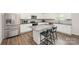 Modern kitchen with stainless steel appliances, granite countertops, and a central island with bar stool seating at 711 Saddlebred Ln, Locust, NC 28097