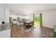 Bright kitchen and dining area with stainless steel appliances, granite counters, and easy access to outdoor area at 711 Saddlebred Ln, Locust, NC 28097