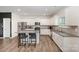 Bright kitchen featuring white cabinetry, granite countertops, stainless appliances, and an island with barstool seating at 711 Saddlebred Ln, Locust, NC 28097