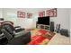 Comfortable living room featuring theater seating, sports memorabilia and a large TV, perfect for entertaining at 711 Saddlebred Ln, Locust, NC 28097