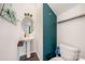 Stylish powder room featuring a pedestal sink, decorative mirror, and unique accent wall, providing a modern touch at 711 Saddlebred Ln, Locust, NC 28097