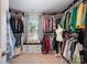Well-organized walk-in closet with custom shelving, ample storage, and a cozy window seat, maximizing space at 711 Saddlebred Ln, Locust, NC 28097