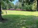 Backyard with a grassy lawn and a few trees at 8095 New St, Mount Pleasant, NC 28124