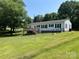Backyard with a wooden deck, fence and grass at 8095 New St, Mount Pleasant, NC 28124