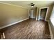 Bedroom featuring wood-look flooring, neutral paint, a ceiling fan and closet at 8095 New St, Mount Pleasant, NC 28124