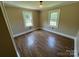 Bedroom featuring two windows, wood-look flooring and neutral paint at 8095 New St, Mount Pleasant, NC 28124