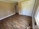 Bedroom shows the hardwood floors, window, closet and open doorway at 8095 New St, Mount Pleasant, NC 28124