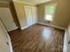 Bedroom with window, closet, hardwood floors, tan walls and white trim at 8095 New St, Mount Pleasant, NC 28124