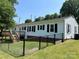 Exterior view of the back of the house shows the back deck at 8095 New St, Mount Pleasant, NC 28124