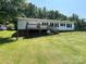 Exterior shot of the back of the house with a grassy hill at 8095 New St, Mount Pleasant, NC 28124