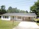 Charming single-story home featuring a covered carport and well-manicured front yard at 8095 New St, Mount Pleasant, NC 28124