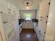 Classic kitchen features white cabinets, countertops and appliances, plus wood-look floors at 8095 New St, Mount Pleasant, NC 28124
