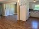 Bright kitchen with white cabinets, wood-look flooring and a view to the adjacent room at 8095 New St, Mount Pleasant, NC 28124