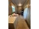 A functional laundry room with washer, dryer, shelving, and a window for natural light at 8095 New St, Mount Pleasant, NC 28124