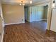 Comfortable living room with updated laminate flooring and stylish light fixture at 8095 New St, Mount Pleasant, NC 28124