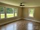Beautiful living room with a ceiling fan and large windows that let in lots of natural light at 8095 New St, Mount Pleasant, NC 28124