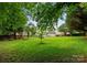 Picturesque backyard with lush greenery, offering a serene and private retreat at 8808 Palmutum Pl, Charlotte, NC 28269