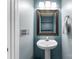 This powder room features a pedestal sink, brushed nickel fixtures, and modern lighting at 8808 Palmutum Pl, Charlotte, NC 28269