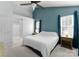 This bedroom features large windows providing natural light and neutral walls, making it cozy at 8808 Palmutum Pl, Charlotte, NC 28269