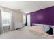 Bright bedroom features built-in bed frame and neutral-toned walls with brick accent wall at 8808 Palmutum Pl, Charlotte, NC 28269