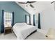 Spacious bedroom offering a ceiling fan and large windows, creating a bright and airy atmosphere at 8808 Palmutum Pl, Charlotte, NC 28269