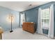 Bedroom bedroom featuring two windows, a dresser, and soft blue walls at 8808 Palmutum Pl, Charlotte, NC 28269