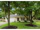 Inviting two-story home with a front porch, lush lawn and mature trees at 8808 Palmutum Pl, Charlotte, NC 28269