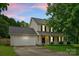 Charming two-story home with a two-car garage, cozy front porch, and well-maintained landscaping at 8808 Palmutum Pl, Charlotte, NC 28269