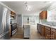 Spacious kitchen featuring stainless steel appliances, wooden cabinets, and a center island at 8808 Palmutum Pl, Charlotte, NC 28269