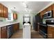 Bright kitchen with stainless steel appliances, wood cabinets, and a view into the dining area at 8808 Palmutum Pl, Charlotte, NC 28269