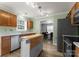 Well-lit kitchen featuring stainless steel appliances, wooden cabinets, and a functional island at 8808 Palmutum Pl, Charlotte, NC 28269