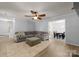 Bright living room with a ceiling fan and a view into the dining area at 8808 Palmutum Pl, Charlotte, NC 28269