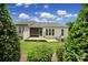 Rear view of the property with green shrubbery and manicured lawn at 9020 Smokey Hill Ln, Fort Mill, SC 29707