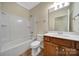 Well-lit bathroom with a shower-tub combo, ceramic tile flooring, a white toilet, and a single sink vanity at 9020 Smokey Hill Ln, Fort Mill, SC 29707