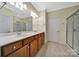 Spacious bathroom with double vanity, tile floor, framed mirrors, and a separate shower at 9020 Smokey Hill Ln, Fort Mill, SC 29707