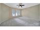 Spacious bedroom offers neutral carpet, paint, trim, a ceiling fan, and lots of natural light at 9020 Smokey Hill Ln, Fort Mill, SC 29707