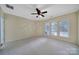 Bright bedroom features neutral carpet, paint, and lots of natural light from the multiple windows at 9020 Smokey Hill Ln, Fort Mill, SC 29707