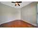 This is a cozy room with hardwood floors, neutral paint, crown molding, and a ceiling fan at 9020 Smokey Hill Ln, Fort Mill, SC 29707