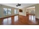 Elegant dining room with hardwood floors, decorative chandelier, and abundant natural light from large windows at 9020 Smokey Hill Ln, Fort Mill, SC 29707